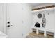 Bright mudroom featuring storage baskets, hooks, and a convenient bench for organization at 4842 E Surrey Ave, Scottsdale, AZ 85254
