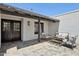 Comfortable patio with stylish seating area, pavers, exterior wall, black trim and black double doors at 4842 E Surrey Ave, Scottsdale, AZ 85254