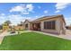Expansive backyard with artificial turf, desert landscaping, and a covered patio at 520 E Ashurst Dr, Phoenix, AZ 85048