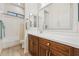 Bathroom with wood cabinets and large mirror with a shower/tub combination in the background at 520 E Ashurst Dr, Phoenix, AZ 85048