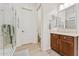 Bathroom featuring a glass enclosed shower, wood cabinets and a view into the commode room at 520 E Ashurst Dr, Phoenix, AZ 85048