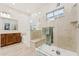 This primary bathroom features a glass shower and a soaking tub below a window at 520 E Ashurst Dr, Phoenix, AZ 85048
