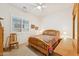 Bedroom with a colorful patchwork quilt on the bed, complemented by a window with white shutters at 520 E Ashurst Dr, Phoenix, AZ 85048