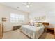 Relaxing bedroom with neutral tones, plantation shutters, carpet, and a decorative headboard at 520 E Ashurst Dr, Phoenix, AZ 85048