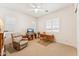 Bedroom featuring two windows, a recliner, a TV, a desk, and a ceiling fan at 520 E Ashurst Dr, Phoenix, AZ 85048
