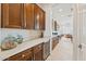 Butler's pantry with wood cabinetry, white countertops, a wine fridge, and plenty of storage space at 520 E Ashurst Dr, Phoenix, AZ 85048
