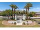 Community entrance with palm trees, landscaping, and a welcoming gate at 520 E Ashurst Dr, Phoenix, AZ 85048