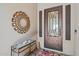 Elegant entryway features a decorative iron front door, tiled console table and stylish decor at 520 E Ashurst Dr, Phoenix, AZ 85048