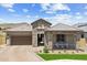 Charming single-story stone home boasts a covered porch with seating and a well-manicured desert landscape at 520 E Ashurst Dr, Phoenix, AZ 85048