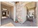Inviting front porch with stone accents, tiled flooring, and cozy seating area for relaxing at 520 E Ashurst Dr, Phoenix, AZ 85048