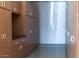 Garage with built-in storage cabinets and shelving units for optimal organization at 520 E Ashurst Dr, Phoenix, AZ 85048