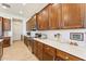 Modern kitchen boasts stainless steel appliances, quartz countertops, and ample wood cabinet storage at 520 E Ashurst Dr, Phoenix, AZ 85048