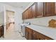 Well-equipped laundry room with ample counter space, storage cabinets, and modern washer and dryer at 520 E Ashurst Dr, Phoenix, AZ 85048