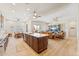 Open-concept living space showcases a large kitchen island, dining area, and living room with built-in shelving at 520 E Ashurst Dr, Phoenix, AZ 85048
