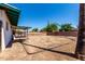 Large backyard space with a covered patio area, enclosed by a brick wall at 539 E Pebble Beach Dr, Tempe, AZ 85282