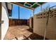 Enclosed backyard with a covered patio, brick privacy wall and a wooden gate at 539 E Pebble Beach Dr, Tempe, AZ 85282