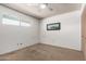 Bright carpeted bedroom with a ceiling fan, ample lighting and closet space for comfortable modern living at 539 E Pebble Beach Dr, Tempe, AZ 85282