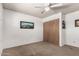 Bright carpeted bedroom featuring a ceiling fan, ample lighting and closet space for comfortable modern living at 539 E Pebble Beach Dr, Tempe, AZ 85282