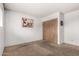 Carpeted bedroom showcasing ample closet space, neutral paint, and a minimalist design for comfortable living at 539 E Pebble Beach Dr, Tempe, AZ 85282
