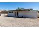 Rear view of the house with low-maintenance yard, security door and desert landscaping at 539 E Pebble Beach Dr, Tempe, AZ 85282