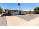 View of the house from the side showing carport and a long driveway at 539 E Pebble Beach Dr, Tempe, AZ 85282
