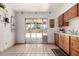 Bright kitchen features sliding glass doors to backyard and tile floor at 539 E Pebble Beach Dr, Tempe, AZ 85282