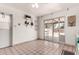 Bright kitchen featuring sliding glass doors to backyard, white walls, tile floors at 539 E Pebble Beach Dr, Tempe, AZ 85282