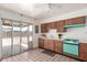Bright kitchen with tile floor, backyard access, colorful stove and white tiled backsplash at 539 E Pebble Beach Dr, Tempe, AZ 85282