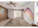 Spacious living room with ceiling fan and sliding doors to outside patio at 539 E Pebble Beach Dr, Tempe, AZ 85282