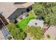 Aerial view of a well-manicured backyard featuring lush lawn, a concrete patio and mature landscaping at 549 E Quentin Ln, San Tan Valley, AZ 85140