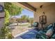 Serene backyard featuring a covered patio, lush landscaping, and a cozy fire pit area at 549 E Quentin Ln, San Tan Valley, AZ 85140