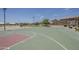 Community basketball court with green and red court, outdoor picnic, and playground in the background at 549 E Quentin Ln, San Tan Valley, AZ 85140
