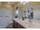 Well-lit bathroom features a double sink vanity and a glass door enclosed shower at 549 E Quentin Ln, San Tan Valley, AZ 85140