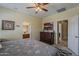Comfortable primary bedroom featuring a ceiling fan and ensuite bathroom access at 549 E Quentin Ln, San Tan Valley, AZ 85140