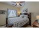 Relaxing primary bedroom featuring a comfy bed, soft window treatments, and charming artwork at 549 E Quentin Ln, San Tan Valley, AZ 85140
