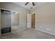 Cozy bedroom with a mirrored closet, a ceiling fan, and neutral-toned walls at 549 E Quentin Ln, San Tan Valley, AZ 85140