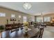 Elegant dining room with a large wooden table and access to the living area at 549 E Quentin Ln, San Tan Valley, AZ 85140