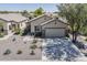Attractive single-story home with desert landscaping, a spacious driveway, and a well-manicured front yard at 549 E Quentin Ln, San Tan Valley, AZ 85140