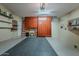 Spacious garage featuring ample cabinet storage, shelving, and epoxy flooring at 549 E Quentin Ln, San Tan Valley, AZ 85140