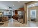 Modern kitchen featuring stainless steel appliances and wooden cabinetry open to the living area at 549 E Quentin Ln, San Tan Valley, AZ 85140