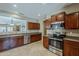 Well-lit kitchen featuring stainless steel appliances, dark wood cabinets, and neutral countertops at 549 E Quentin Ln, San Tan Valley, AZ 85140