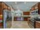Modern kitchen featuring stainless steel appliances, granite countertops, and tile flooring at 549 E Quentin Ln, San Tan Valley, AZ 85140