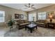 Cozy living room featuring comfortable seating, neutral tones, and natural light from bright windows at 549 E Quentin Ln, San Tan Valley, AZ 85140