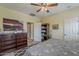 Well-lit bedroom with a patterned bedspread, decorative furniture, and a ceiling fan at 549 E Quentin Ln, San Tan Valley, AZ 85140