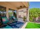 Cozy covered patio with comfortable seating and lush landscaping, ideal for relaxing outdoors at 549 E Quentin Ln, San Tan Valley, AZ 85140