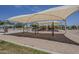 Community playground with swings and play structures under a shade canopy for outdoor fun at 549 E Quentin Ln, San Tan Valley, AZ 85140