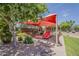 Community playground with red sunshade, slides, green grass, and desert landscaping around the play area at 549 E Quentin Ln, San Tan Valley, AZ 85140