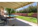 Covered patio overlooks a lush backyard with a sparkling swimming pool at 6009 W Medlock Dr, Glendale, AZ 85301