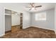 Bright bedroom with a ceiling fan, natural light, and mirrored closet at 6009 W Medlock Dr, Glendale, AZ 85301