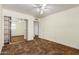 Bright bedroom with a ceiling fan, natural light, and mirrored closet at 6009 W Medlock Dr, Glendale, AZ 85301